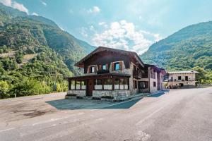 a house on the side of a road with mountains at Meublé la Ciastella in Vinadio