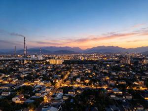 an aerial view of a city at night at Gras Business Hotel in Bishkek