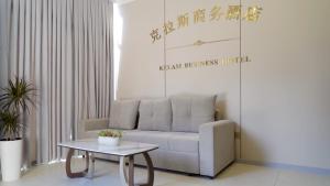 a living room with a couch and a table at Gras Business Hotel in Bishkek +35 photos