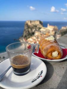 a cup of coffee next to a plate of pastries at La Stella dei Venti in Scilla
