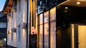 a building with lights in the windows at night at Gras Business Hotel in Bishkek