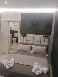 a bedroom with a large bed with two towels on it at Sogno nella Corte in Bitonto +45 photos