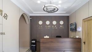 a lobby with a reception desk in a building at Gras Business Hotel in Bishkek
