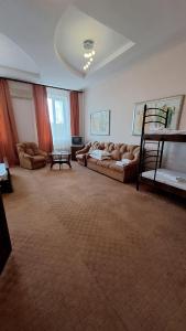 a large living room with couches and a bed at Барселона in Odesa