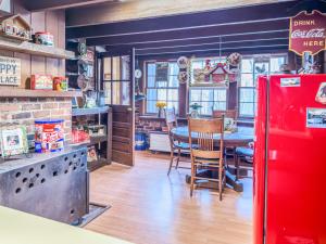 a kitchen with a table and a red refrigerator at A Charming Nature Retreat in Greensboro