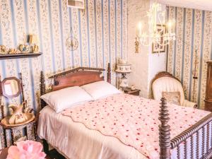 a bedroom with a bed and blue and white wallpaper at A Charming Nature Retreat in Greensboro
