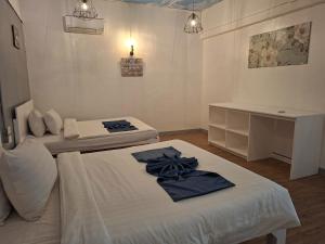 a white room with two beds and a desk at Bolabog Beach Resort in Boracay