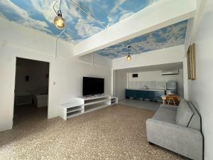 a living room with a couch and a flat screen tv at Bolabog Beach Resort in Boracay