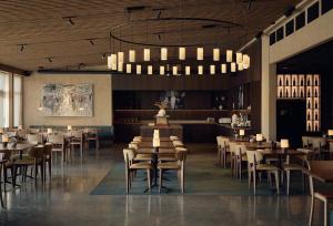 a restaurant with tables and chairs in a room at Marholmen in Norrtälje