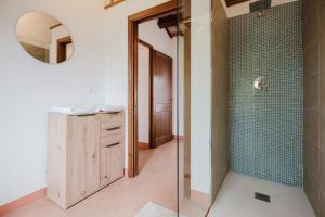 a bathroom with a shower and a sink and a mirror at B&B Lallabiló in San Clemente +10 photos
