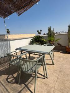 a table and chairs on a patio at Apartamentos RG Suites Jardines de Murillo in Seville