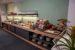 a kitchen with a counter with food on it at Hotel Zofingen in Zofingen +16 photos