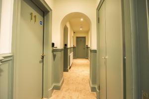 a hallway with an archway and a row of doors at The Limes in York