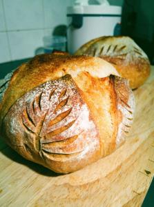 two loaves of bread sitting on a cutting board at Kama Siri Koh Kood in Ko Kood