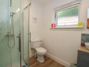 a bathroom with a toilet and a glass shower at Allt An Dorran in Acharacle +44 photos