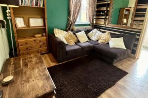 a living room with a couch and a table at Cosy and secluded brook-side lodge in Sleaford