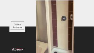 a bathroom with a shower with a toilet and a sink at RV kavinė motelis in Salaperaugis