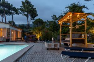 a patio with a gazebo next to a pool at Villa Can Gavarres in Bell-Lloch