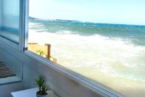 a view of the ocean from a window at 27m with terrace - first row sea view in Six-Fours-les-Plages +6 photos