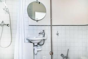 a bathroom with a sink and a mirror at Charming Studio 2P - Marais in Paris +4 photos