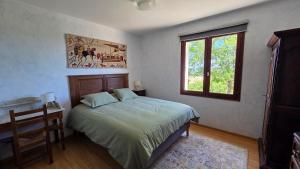 a bedroom with a bed and a window at Colombier de Scandaillac in Saint-Eutrope-de-Born +13 photos