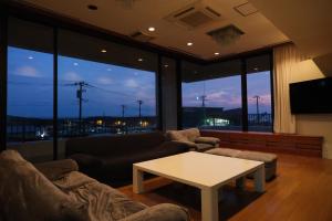 a living room with a couch and a table at Villa aco's in Ako