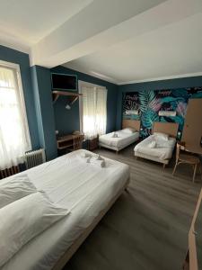 a bedroom with two beds and blue walls at Le Clos Normand in Troarn +28 photos