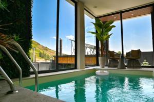 a swimming pool in a house with a view of a bridge at Sunken Tsaghkadzor in Tsaghkadzor