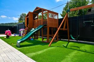 a playground with a slide on the grass at Sunken Tsaghkadzor in Tsaghkadzor