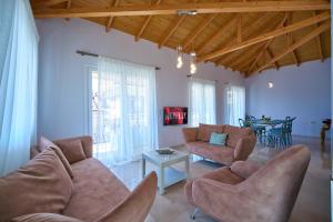 a living room with two couches and a table at Irida Home in Parga