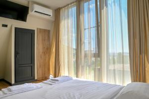 a bedroom with a bed and a large window at Sunken Tsaghkadzor in Tsaghkadzor +24 photos
