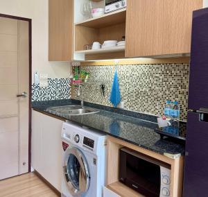 a kitchen with a sink and a washing machine at Nai Thon Condo Unit in Nai Thon Beach +23 photos