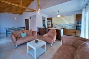 a living room with two couches and a table at Irida Home in Parga