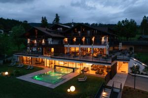 an aerial view of a large house with a swimming pool at Hotel Oberwirt in Verano