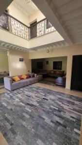 a large living room with couches and a balcony at Le Paisible Atlas in Marrakesh