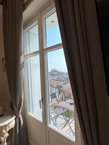a window with a view of a city at Villa Regina in Cisterna dʼAsti