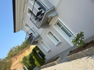 a white building with stairs and a balcony at Villa Regina in Cisterna dʼAsti
