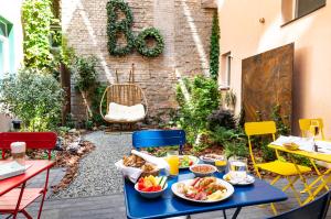 a blue table with food on a patio with chairs at Bo18 Hotel Superior in Budapest