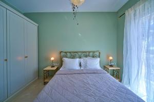 a bedroom with a large bed with two night stands at Irida Home in Parga