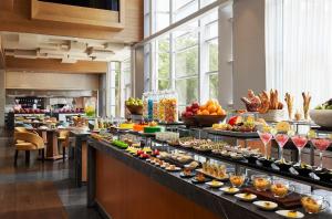 a buffet line with many different types of food at Hyatt Regency Ahmedabad in Ahmedabad