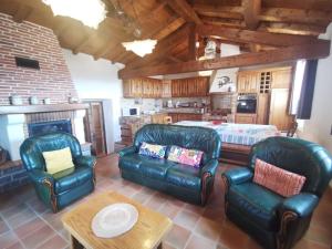 a living room with leather furniture and a bed at Côté séranne in Saint-André-de-Buèges