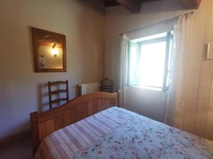 a bedroom with a bed and a window at Côté séranne in Saint-André-de-Buèges