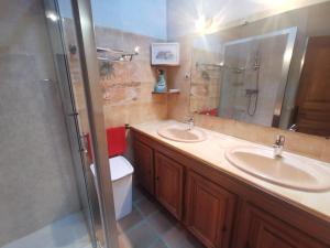 a bathroom with two sinks and a toilet and a mirror at Côté séranne in Saint-André-de-Buèges +14 photos