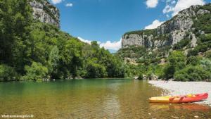 a boat sitting on the shore of a river at Côté séranne in Saint-André-de-Buèges