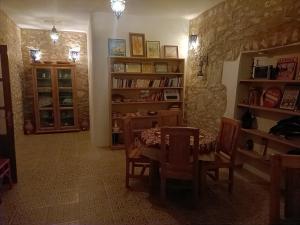 a dining room with a table and bookshelves at Room in Villa Dar Albatros in Sidi Kaouki