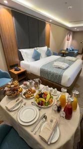 a table with plates of food on it in a hotel room at Attawfeek Hotel in Tripoli