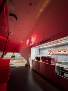 a fast food restaurant with red lights on the wall at The 50th Uthai Thani in Uthai Thani