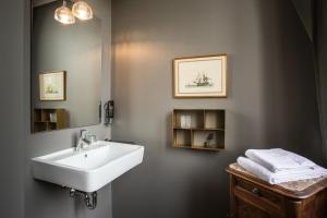a bathroom with a sink and a mirror at Hotel Heimathafen in Lörrach