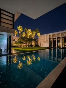 an infinity pool in a house at night at The 50th Uthai Thani in Uthai Thani