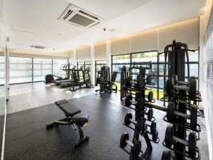 a gym with a bunch of treadmills and machines at The 50th Uthai Thani in Uthai Thani